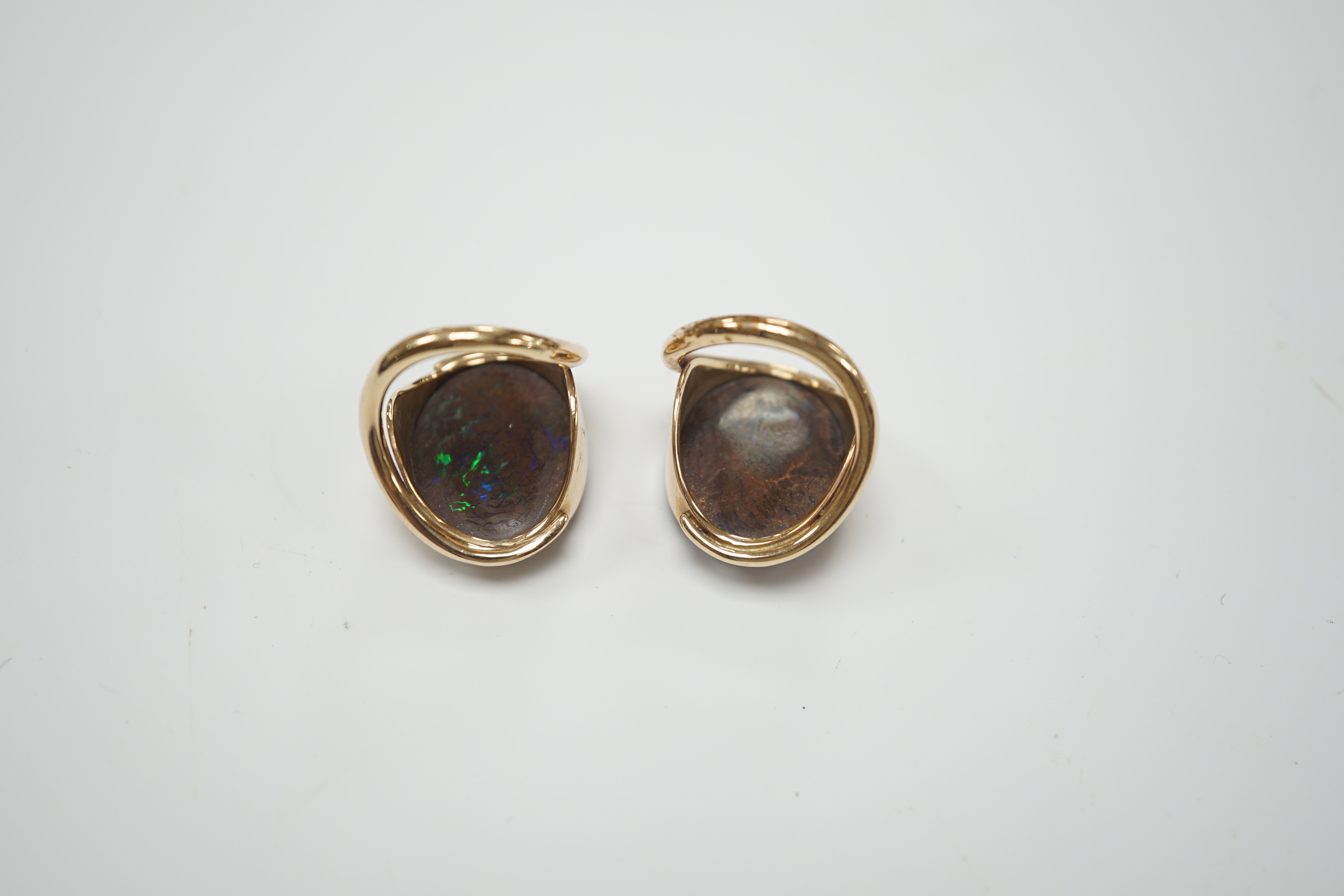 A pair of yellow metal and oval boulder opal set dress rings, both size M, gross weight 20 grams.